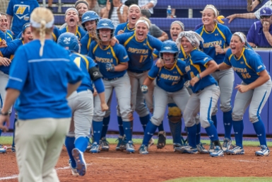 HM SPORTS FEATURE: Austin Bachand, Daily News Record---Hofstra junior Caryn Bailey gets welcomed to home base by the rest of her team after she hit a home run during their CAA Championship game against James Madison University on Thursday, May 7.