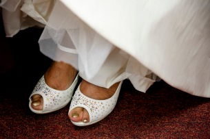 The toes of Elizabeth Lawrence peek out from her shoes underneath her wedding dress at New Weeping Mary Missionary Baptist Church in Chesapeake, Va., on Saturday, December 10, 2016.