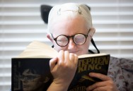 Tonya Davison, 36, has two sets of glasses - one for reading and one for distance. Here Tonya tests her new reading glasses by reading a book from her favorite author, Stephen King, comfortably at Dr. David Armstrong's office in Roanoke.