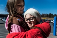 Emmeline Harris, 8, hugs Abigail Eggleston, 7, while selling cookies with their Girl Scout troop on Saturday Feb. 4, 2017 in Madison Heights, Va.