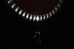 A visitor is illuminated while passing through the rotunda at the United States Capitol on Wednesday May 03, 2017 in Washington, DC.