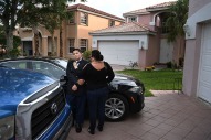 Kyle Laman, 15, has his bow tie adjusted by his mother, Marie Laman outside the family's home before Kyle attended a JROTC military ball on Saturday April 21, 2018 in Coral Springs, FL. His parents had to coax him out of the house to attend the event. Kyle was shot in during a deadly mass shooting at Marjory Stoneman Douglas High School on February 14, 2018.